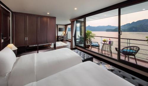 a bedroom with a bed and a view of the water at Mon Cheri Cruises in Ha Long