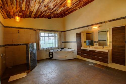 a large bathroom with a tub and a sink at Naivasha Kongoni Lodge in Naivasha
