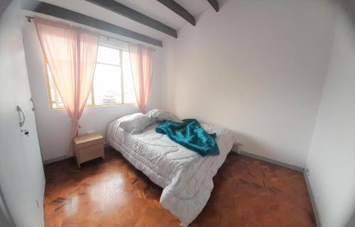 a small bedroom with a bed and a window at Casa Jaguar Manizales sector Cable in Manizales