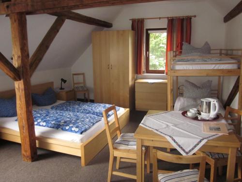 a bedroom with two bunk beds and a table at Schultenhof in Balve