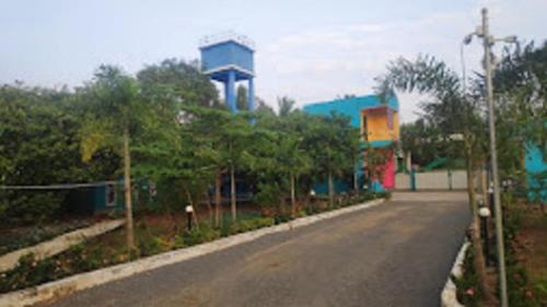 an empty road with a building in the background at Paradise Forest Resort in Puducherry