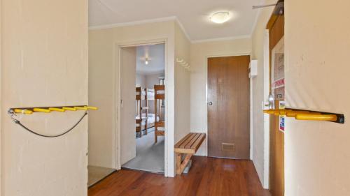 a living room with a hallway with a wooden floor at 1750 Hotham 11 in Mount Hotham