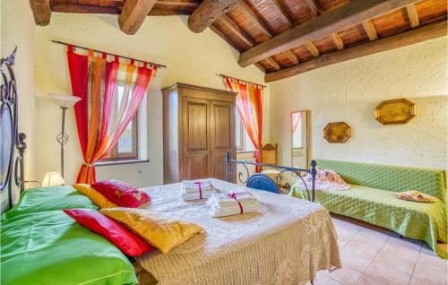 a bedroom with two beds with colorful pillows at Fornione in Fabbriche di Vallico