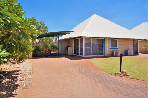 a house with a white roof and a brick driveway at Osprey Holiday Village Unit 101 2 Bedroom in Exmouth