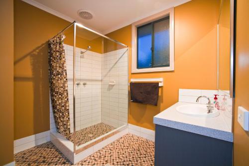 a bathroom with a shower and a sink at 9 Skipjack Circle in Exmouth