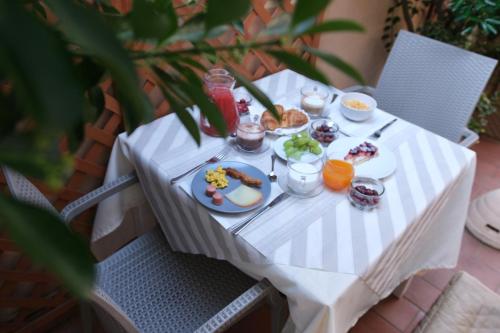 a white table with a plate of food on it at Hotel Tahiti in Viareggio