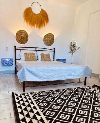 a bedroom with a bed and a rug at HOKKUM STUDIOS in Kokkari