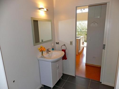 a bathroom with a sink and a mirror at Great Escape - Whangamata Holiday Home in Whangamata