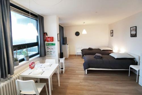 ダルムシュタットにある1 room flat in Darmstadtのベッド、テーブル、ソファが備わる客室です。