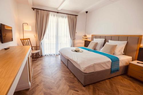 Кровать или кровати в номере Palmonte Suites Hotel & SPA