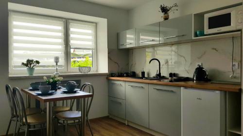 a kitchen with a small table and a sink at Agroturystyka u Marty in Tylicz