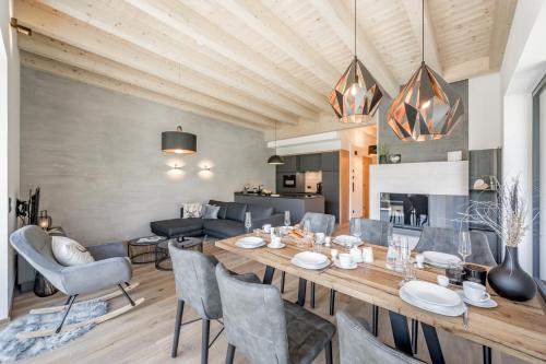 a dining room with a large wooden table and chairs at Mountain Moments in Sautens