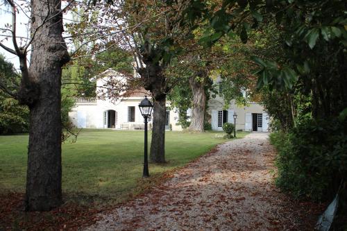 a street light in front of a house with trees at Chambres d'hôtes les Marronniers in Bordeaux