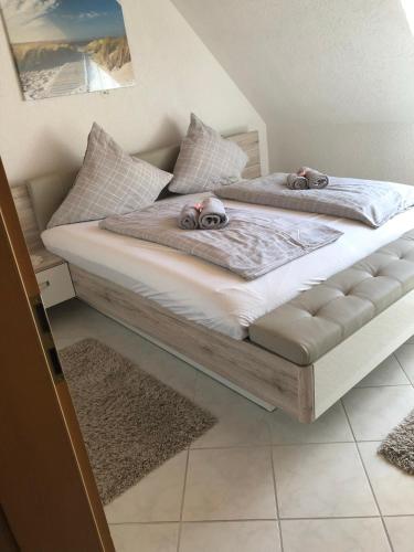 a bed with two stuffed animals sitting on top of it at Ferienwohnung Bodensee LA in Langenargen