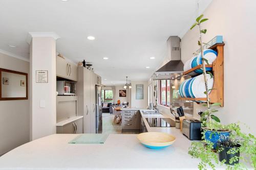 a kitchen with a large counter top in a room at Sandy Feet - Papamoa Beach Holiday Home in Papamoa