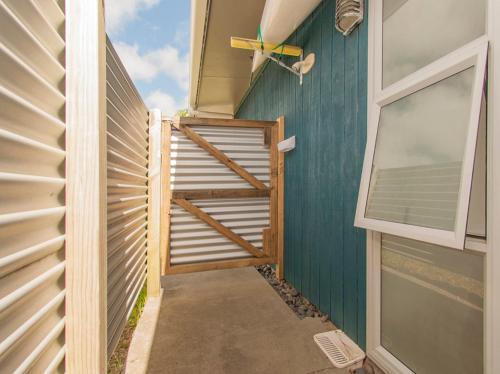 a stairway leading up to a house with a window at Sands Beach House - Matarangi Holiday Home in Matarangi