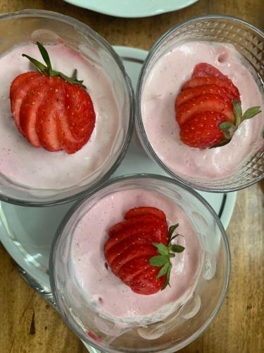 four bowls with strawberries in them on a plate at Le prieuré de Saint Thibault in Saint-Thibault-des-Vignes