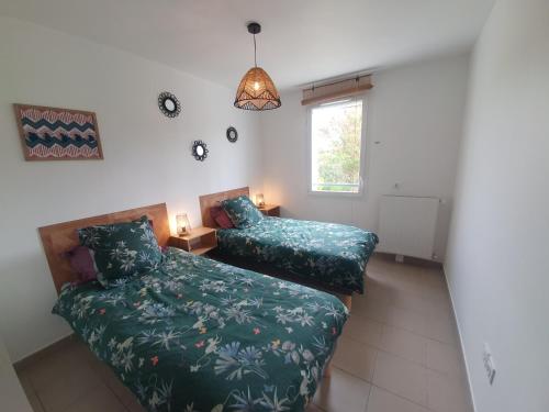 a bedroom with a bed and a couch and a window at T3 Le Lou-Piscine & Parking - 5min des thermes in Gréoux-les-Bains