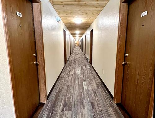 a long hallway with wooden floors and wooden doors at Beartooth Hideaway Inn & Cabins in Red Lodge