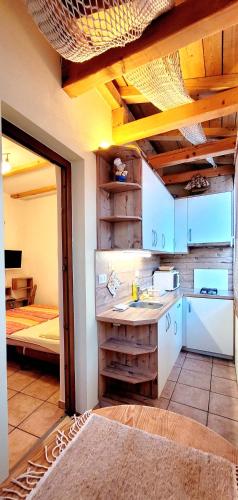 a kitchen with a sink and a bed in a room at Apartmaji Sonce Izola in Izola