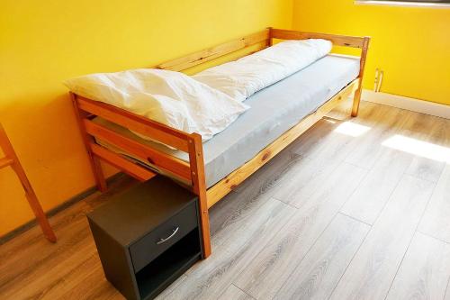 a bed in a room with a yellow wall at 4 room apartment in Düren in Düren - Eifel