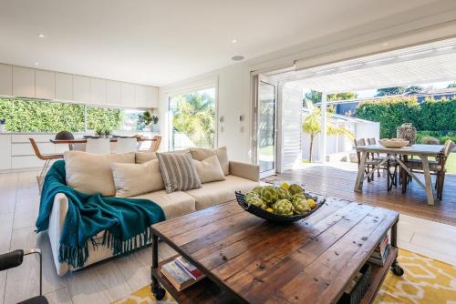 a living room with a couch and a table at Moa Magic - Oneroa Holiday Home in Oneroa