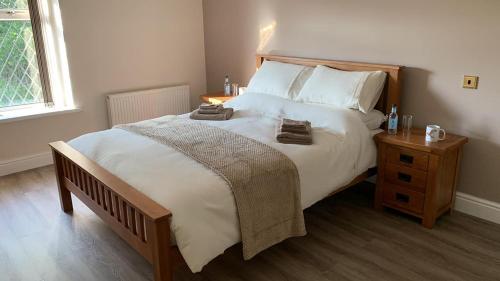a bedroom with a large bed with a wooden headboard at The Cottage Inn in Llandeilo