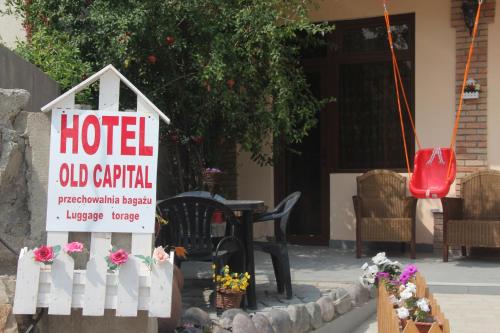 a sign that says hotel old capital and a table at Old Capital in Mtskheta