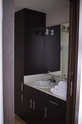 a bathroom with a sink and a mirror at “Arena” Estudio con vistas al mar in Jávea