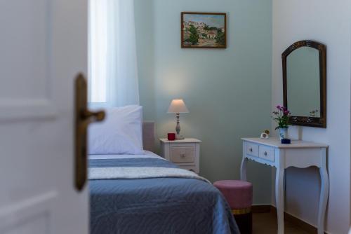 sypialnia z łóżkiem, lustrem i stołem w obiekcie Villa Remedio w mieście Néon Khoríon