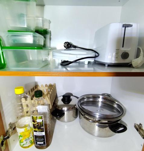 a kitchen counter with a stove and some food at PiPi's House in Néa Artáki