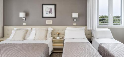 Postel nebo postele na pokoji v ubytování Hotel Carignano