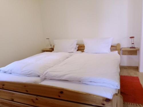 a bedroom with two beds with white sheets and pillows at Hof Kranichweide, Ferienwohnung "Granilager" in Saal