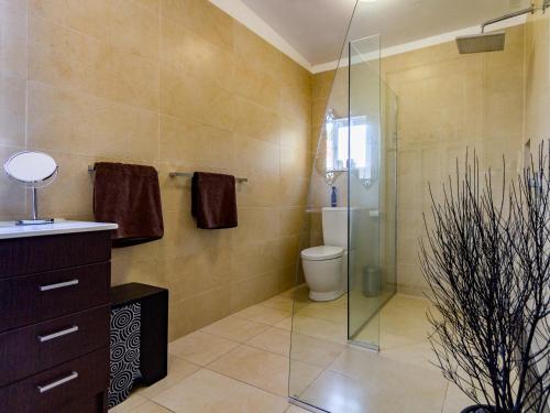 a bathroom with a toilet and a glass shower at Stag & 3 Pigs - Ohakune Holiday Home in Ohakune