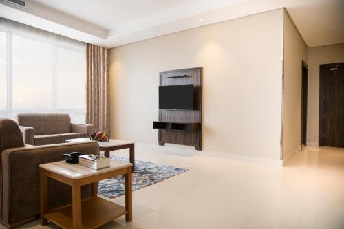 a living room with a couch and a table at Swiss Blue Hotel - Hera in Jeddah