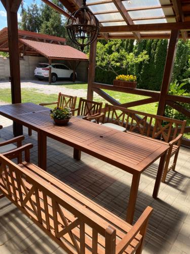 a wooden picnic table and chairs on a patio at VILLA ANGEL in Rožňava