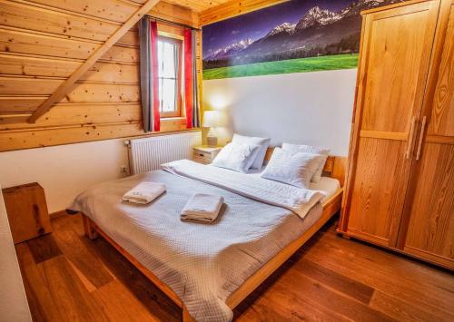 a bedroom with a bed with two towels on it at Willa na Borku in Ciche