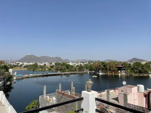 a view of a river with boats in it at Boraj Haveli Guest House in Udaipur