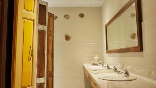 a bathroom with three sinks and a mirror at FINCA ALEGRANZA in Torrelavega