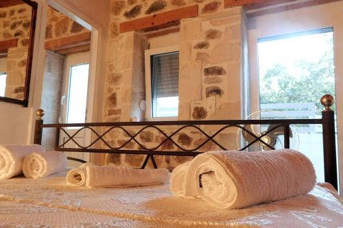 a bedroom with a bed with towels on it at Orne Magical Retreat in Orné