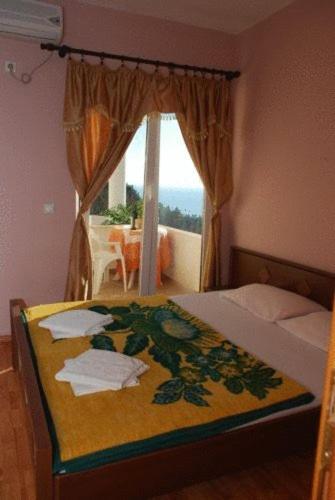a bedroom with a bed and a window with a view at Firenze Apartments in Ulcinj