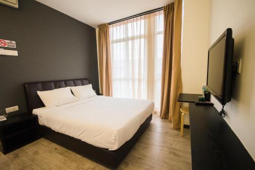 Un pat sau paturi într-o cameră la Sandy Hotel Malacca