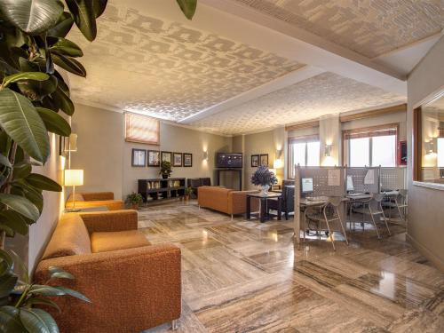 a living room with couches and a dining room at Hotel Delle Nazioni in Florence