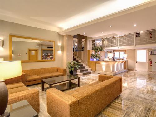 a living room with couches and a table at Hotel Delle Nazioni in Florence