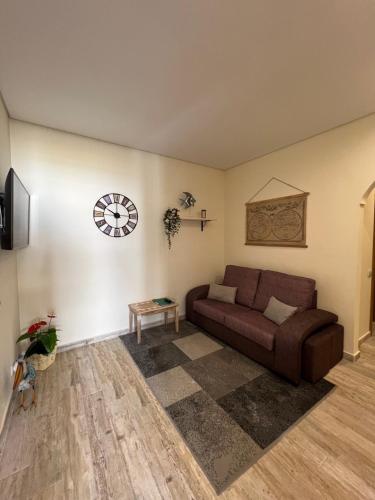 a living room with a couch and a table at Time Holiday´s House in Olhão