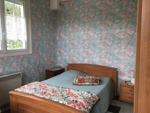 a bedroom with a bed with a pillow on it at Halte Saltusienne in Saint-Julien-du-Sault