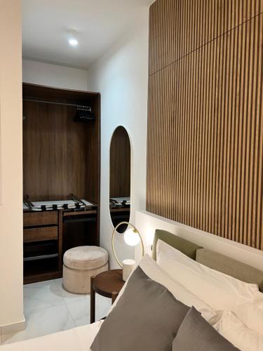 a bedroom with a bed and a table and a desk at infinity Castellabate b & b di Charme in Santa Maria di Castellabate