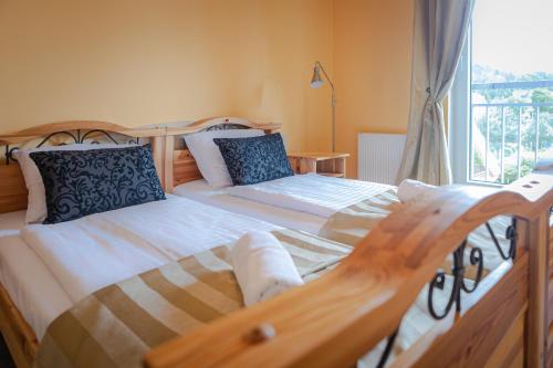 a bedroom with two beds and a window at Apartamenty Polanica MyWeek in Polanica-Zdrój