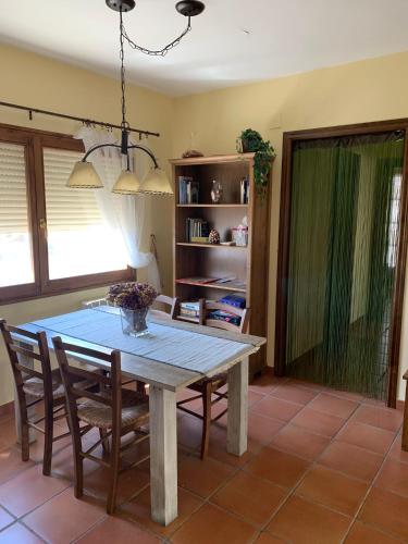a dining room with a table and some chairs at La Casa de Baix in Torre del Compte