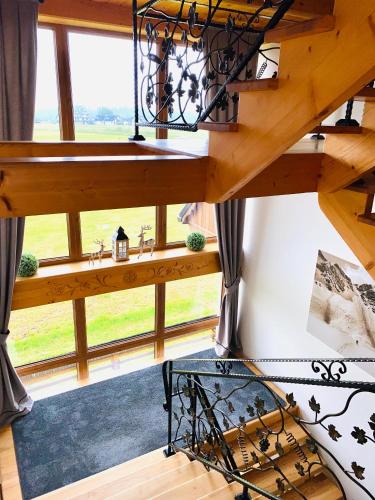 a view from the loft of a house with a large window at Willa na Borku in Ciche